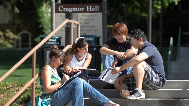 students sitting on the steps in front of Cragmor Hall talking