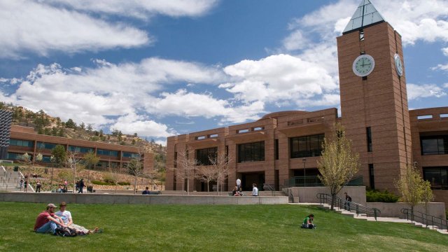 students relaxing on the lawn at El Pomar Plaza