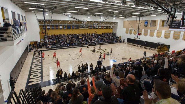 women's basketball team playing to a packed house