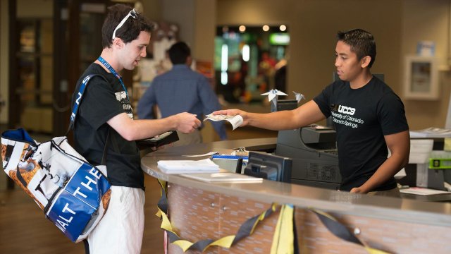 a student help desk worker helping another student