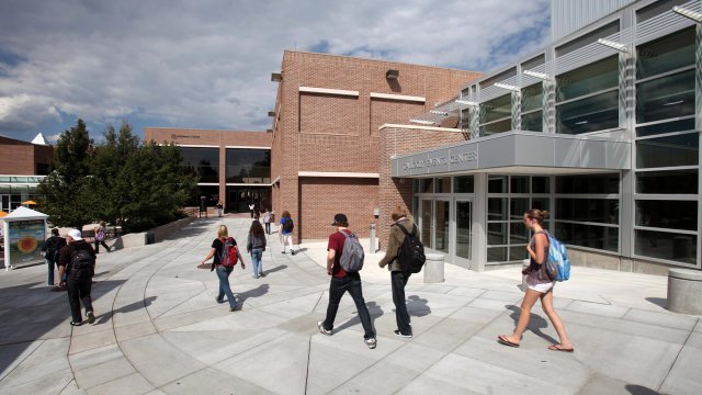 students walking outside Gallogly Events Center towards the Upper University Center