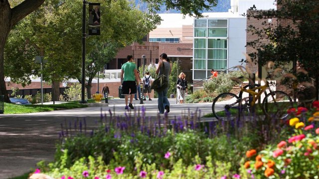 students walking outside towards the Upper University Center