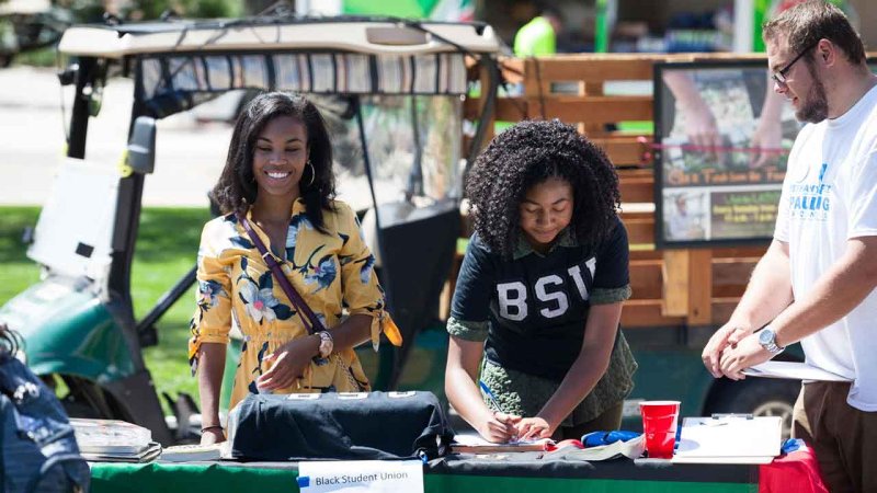 student club registering people at outdoor fair