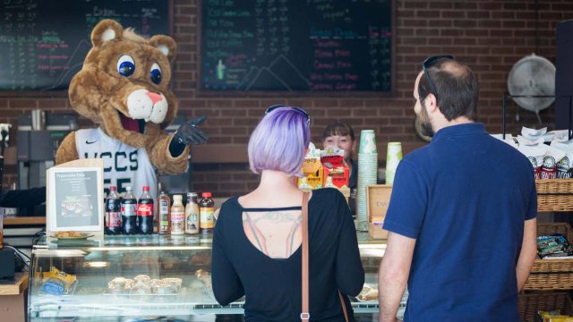 Clyde the mascot working the register at Sanitorium Grounds