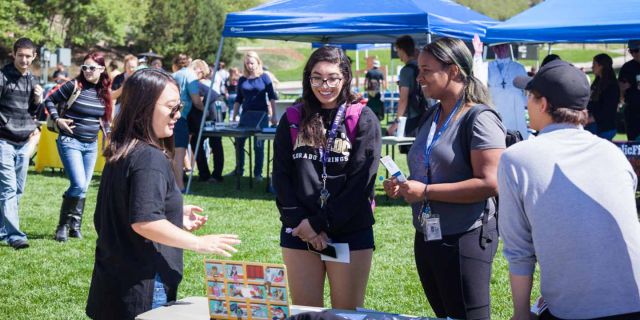 students attending a student fair on the West Lawn