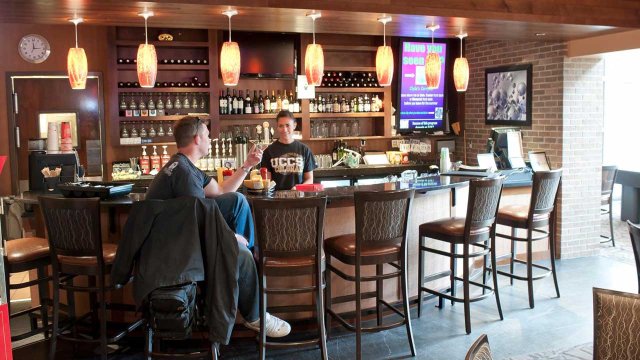 student working behind the bar at Clyde's Gastropub